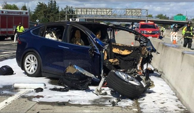 FILE - In this March 23, 2018 file photo provided by KTVU, emergency personnel work a the scene where a Tesla electric SUV crashed into a barrier on U.S. Highway 101 in Mountain View, Calif. The test results by AAA released Thursday, Nov. 15, 2018, come after several highly publicized crashes involving Tesla vehicles that were operating on the company&#x27;s system named &amp;quot;Autopilot.&amp;quot; The National Transportation Safety Board is investigating some of the crashes, including the March fatality that involved a Model X that struck a freeway barrier. (KTVU via AP, File)