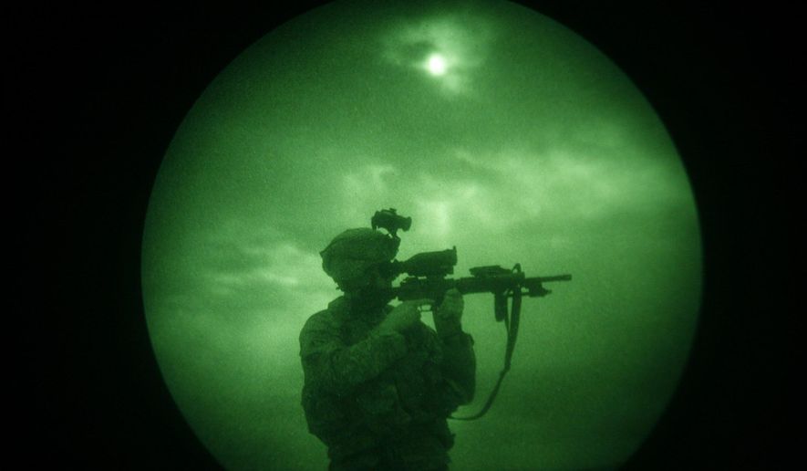 In this Monday, April 21, 2008 file photo, a U.S soldier looks through the scope of his weapon during a night patrol in Mandozai, in Khost province, Afghanistan, seen through night vision equipment. About 400,000 veterans had a PTSD diagnosis in 2013, according to the Veterans Affairs health system. (AP Photo/Rafiq Maqbool)