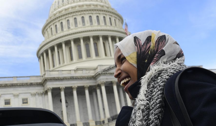 Rep.-elect Ilhan Omar, D-Minn., smiles during an interview following a photo opportunity on Capitol Hill in Washington, Wednesday, Nov. 14, 2018, with the freshman class. (AP Photo/Susan Walsh)