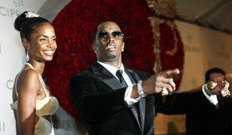 File-This Nov. 4, 2004, file photo shows Sean &amp;quot;P. Diddy&amp;quot; Combs directing photographers as they sing &amp;quot;Happy Birthday,&amp;quot; to him as his date Kim Porter, left, listens, after Combs arrived for his 35th birthday celebration at Cipriani on Wall Street in New York.  Porter, Diddy&#39;s former longtime girlfriend and the mother of three of his children, has died. A representative for Combs confirmed the death of the 47-year-old on Thursday, Nov. 15, 2018. No further details were immediately available. (AP Photo/Kathy Willens, File)