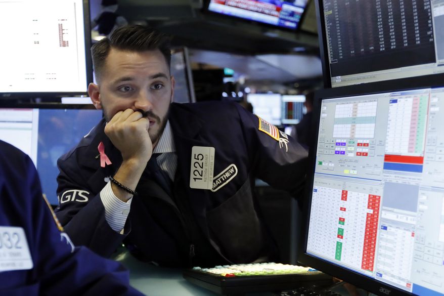 FILE- In this Oct. 23, 2018, file photo specialist Matthew Grenier works on the floor of the New York Stock Exchange. Even the most balanced investors have gotten knocked on their heels this year. Typically, spreading one’s bets across several different types of investments has helped deliver steadier returns. When U.S. stocks slide, say, bonds and gold can hopefully help offset the losses. Or maybe stocks abroad will hold up better than their U.S. counterparts. (AP Photo/Richard Drew, File)