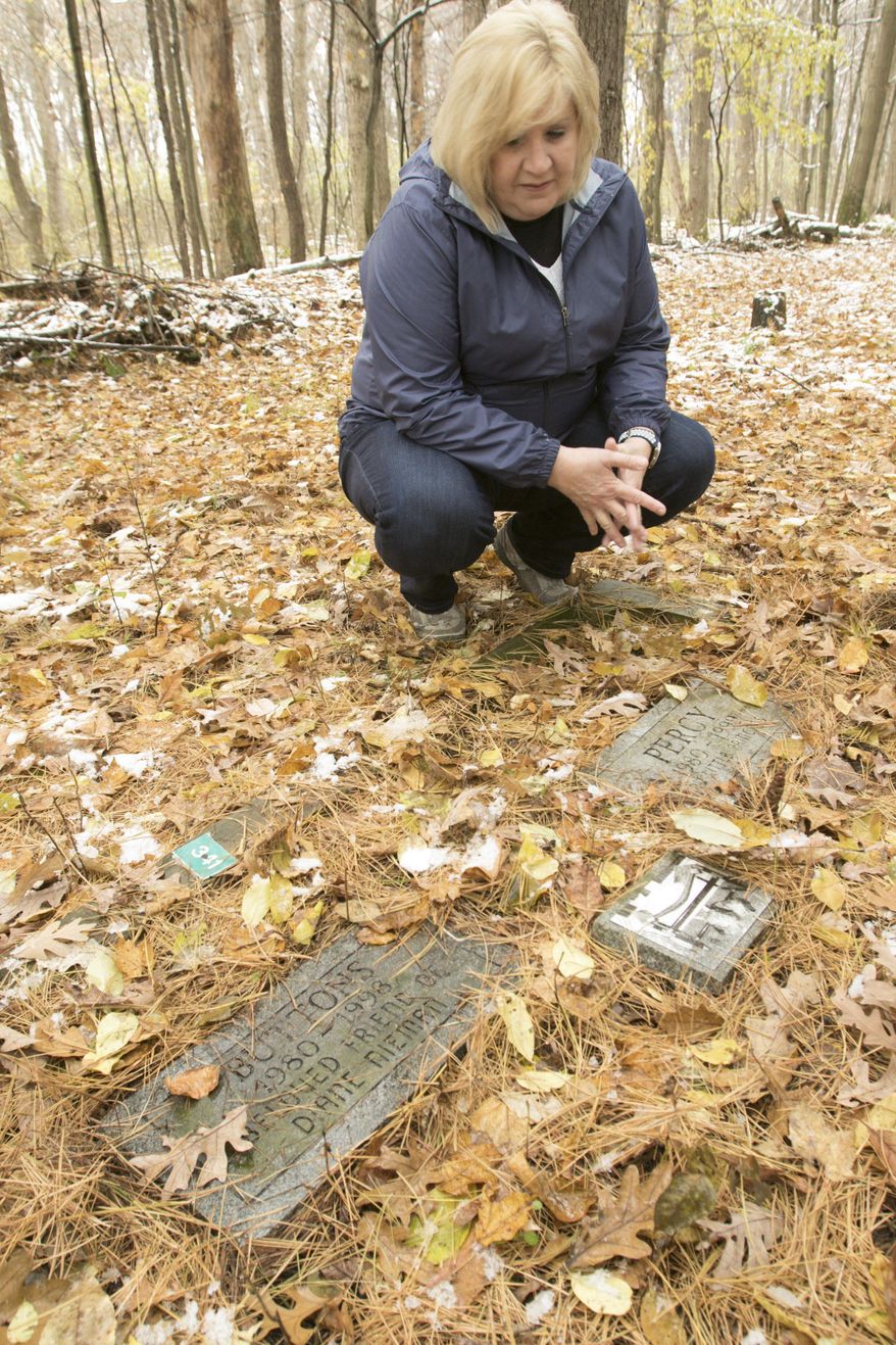 Waterford resident Diane Rousseau visits her cats at a pet cemetery in Genoa Township, Mich., on Friday, Nov. 9, 2018. The cemetery is now closed after the lease expired, leaving Rousseau uncertain and upset about the final resting place of her pets. (Gillis Benedict /Livingston County Daily Press & Argus via AP)