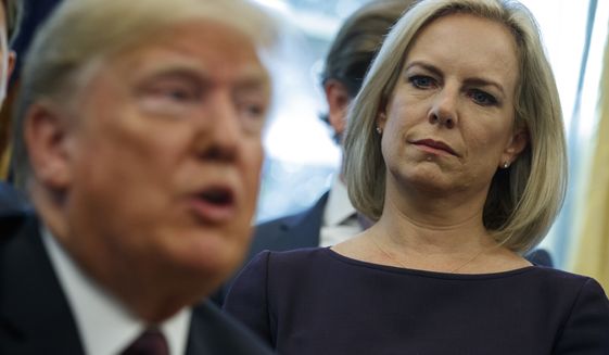 Secretary of Homeland Security Kirstjen Nielsen looks on as President Donald Trump speaks during a signing ceremony of the &quot;Cybersecurity and Infrastructure Security Agency Act,&quot; in the Oval Office of the White House, Friday, Nov. 16, 2018, in Washington. (AP Photo/Evan Vucci)