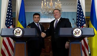 Secretary of State Mike Pompeo shake hands with Ukrainian Foreign Minister Pavlo Klimkin after speaking to the media at the Department of State Friday, Nov. 16, 2018, in Washington. (AP Photo/Jose Luis Magana) **FILE**