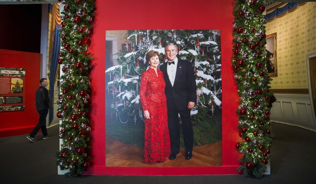A photo of President George W. Bush and Laura Bush  is displayed at a Christmas exhibit at The George W. Bush Presidential Center and Library on Thursday, Nov. 15, 2018 on the SMU campus in Dallas. The exhibit, called &amp;quot;Deck the Halls and Welcome All: Christmas at the White House 2006,&amp;quot; opened Thursday and runs through Jan. 6.  (Ashley Landis /The Dallas Morning News via AP)