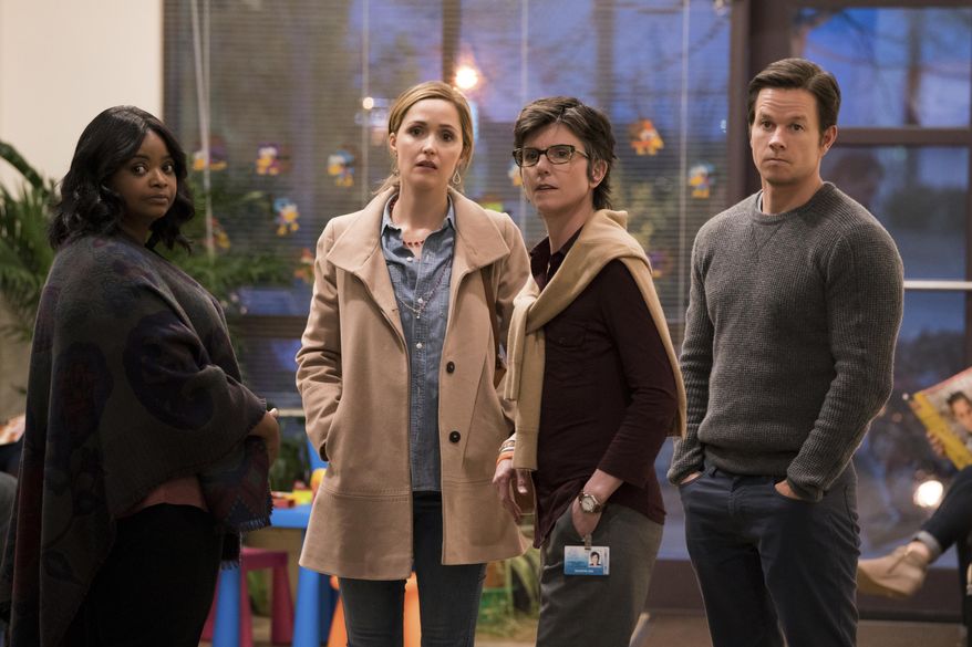 This image released by Paramount Pictures shows Octavia Spencer, from left, Rose Byrne, Tig Notaro and Mark Wahlberg in a scene from "Instant Family." Wahlberg may be known for his tough guy image thanks to movies including “Mile 22” and “The Departed,” or for his straight up comedic roles like in “Ted,” but he tugs at the heartstrings in his latest movie “Instant Family.” Out Friday, it stars Wahlberg and Rose Byrne as spouses adopt three siblings. The story is based on director and co-writer Sean Anders’ own adoption experience. (Hopper Stone/Paramount Pictures via AP)