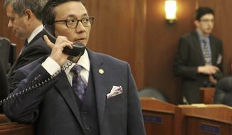 FILE - This Jan. 16, 2018, photo shows Alaska state Rep. Scott Kawasaki, a Fairbanks Democrat, talking on a telephone before the start of the legislative session at the state Capitol in Juneau, Alaska. Republican Alaska Senate President Pete Kelly appears to have lost his re-election bid but told The Associated Press that he&#39;s leaving open the option of a recount. Ballots tallied Friday, Nov. 16, 2018, show Kawasaki widening his lead to 173 votes in the Fairbanks race. (AP Photo/Mark Thiessen, File)