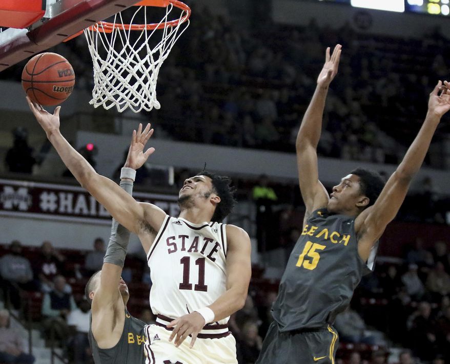 Mississippi State guard Quinndary Weatherspoon (11) drives to the basket between Long Beach State guards Ron Freeman and Deishuan Booker (15) during the first half of an NCAA college basketball game Friday, Nov. 16, 2018, in Starkville, Miss. (AP Photo/Jim Lytle)