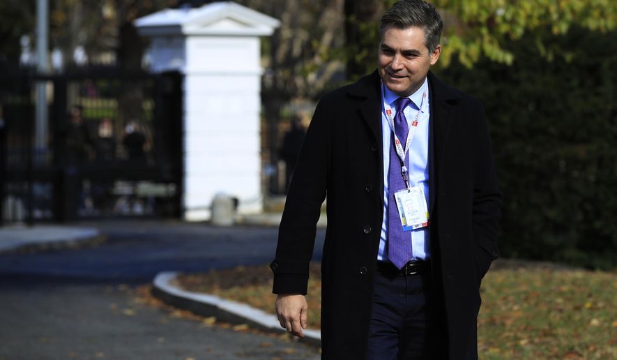 CNN&#x27;s Jim Acosta walks on the North Lawn driveway upon returning back to the White House in Washington, Friday, Nov. 16, 2018. Judge asked the White House to immediately return press credentials of Jim Acosta. (AP Photo/Manuel Balce Ceneta)