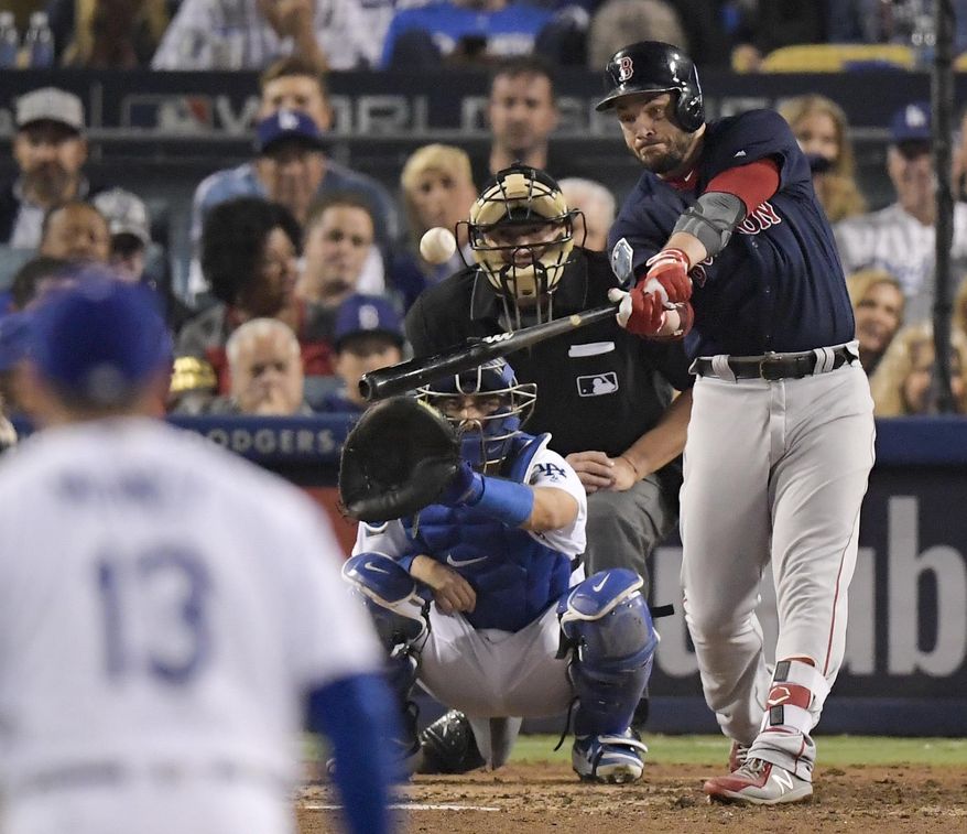 FILE - In this Oct. 28, 2018, file photo, Boston Red Sox's Steve Pearce, right, hits a home run against the Los Angeles Dodgers during the eighth inning in Game 5 of the World Series baseball game in Los Angeles. The Red Sox have re-signed Pearce to a one-year deal worth $6.25 million. Boston announced the agreement on Friday, Nov. 16, 2018. (AP Photo/Mark J. Terrill, File)