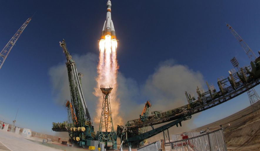 FILE - In this Thursday, Oct. 11, 2018 file photo, the Soyuz-FG rocket booster with Soyuz MS-10 space ship carrying a new crew to the International Space Station, ISS, blasts off at the Russian leased Baikonur cosmodrome, Kazakhstan. A Russian Soyuz rocket has put a cargo ship en route to the International Space Station, clearing the way for the next crewed mission. The launch on Friday, Nov. 16 of the Progress MS-10 resupply ship from Baikonur in Kazakhstan marked the fourth successful liftoff of a Soyuz since an crew launch last month. A Soyuz-FG rocket carrying NASA astronaut Nick Hague and Roscosmos' Alexei Ovchinin failed two minutes into its flight on Oct. 11. (AP Photo/Dmitri Lovetsky, file)