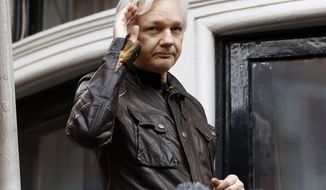 FILE - In this May 19, 2017, file photo, WikiLeaks founder Julian Assange greets supporters from a balcony of the Ecuadorian embassy in London. The Justice Department inadvertently named Assange in a court filing in an unrelated case that raised immediate questions about whether the WikiLeaks founder had been charged under seal. Assange’s name appears twice in an August 2018 filing from a prosecutor in Virginia in a separate case involving a man accused of coercing a minor. (AP Photo/Frank Augstein, File)