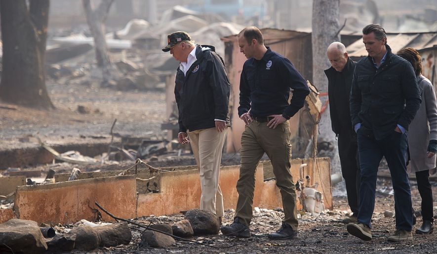 President Donald Trump,  from left, FEMA Administrator Brock Long, California Gov. Jerry Brown, Gov.-elect Gavin Newsom and Paradise Mayor Jody Jones tour the Skyway Villa Mobile Home and RV Park during Trump&#39;s visit of the Camp Fire in Paradise, Calif., Saturday, Nov. 17, 2018. Trump went to Northern California on Saturday to survey the devastation from the nation&#39;s deadliest wildfire in a century. (Paul Kitagaki Jr./The Sacramento Bee via AP, Pool)