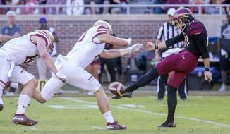 Boston College&#39;s Hunter Long blocks a punt but commits a roughing the kicker penalty against Florida State punter Logan Tyler in the first quarter of an NCAA college football game in Tallahassee, Fla., Saturday, Nov. 17, 2018. (AP Photo/Mark Wallheiser)