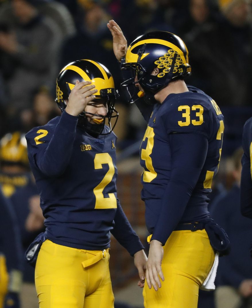 Michigan place kicker Jake Moody (2) celebrates kicking a 29-yard field goal with long snapper Camaron Cheeseman (33) in the second half of an NCAA college football game against Indiana in Ann Arbor, Mich., Saturday, Nov. 17, 2018. Michigan won 31-20. (AP Photo/Paul Sancya) ** FILE **