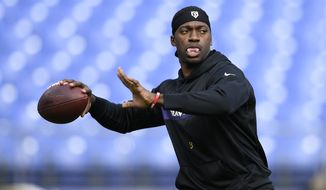 Baltimore Ravens quarterback Robert Griffin III warms up before an NFL football game against the Cincinnati Bengals, Sunday, Nov. 18, 2018, in Baltimore. (AP Photo/Nick Wass)