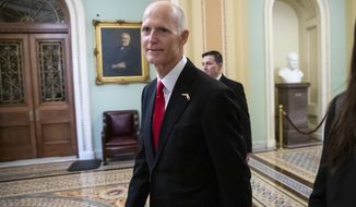 FILE- In this Wednesday, Nov. 14, 2018, file photo Florida Gov. Rick Scott arrives for a meeting with Majority Leader Mitch McConnell, R-Ky., and new GOP senators at the Capitol in Washington. Scott is leading incumbent Sen. Bill Nelson in the state’s contentious Senate race. Official results posted by the state on Sunday, Nov. 18, showed Scott ahead of Nelson following legally-required hand and machine recounts. State officials will certify the final totals on Tuesday. (AP Photo/J. Scott Applewhite, File)