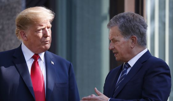 In this July 16, 2018 file photo, U.S. President Donald Trump, left, talks with Finnish President Sauli Niinisto as they pose for a photo in Helsinki, Finland. Niinisto said in an interview published on Sunday, Nov. 18, 2018, that he briefed Trump in the wake of the California wildfires on how the Nordic country effectively monitors its substantial forest resources with a well-working surveillance system. (AP Photo/Pablo Martinez Monsivais, File)