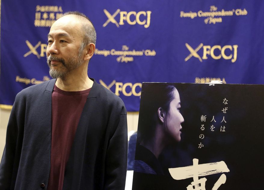 In this Nov. 7, 2018, photo, Japanese director Shinya Tsukamoto speaks to reporters about his latest film "Killing" during a press conference in Tokyo. He said he turned to the Japanese masters for inspiration but also emulated the way Martin Scorsese gave free rein to his actors, a technique he learned when he was cast in "Silence," to play a Christian martyr. "Killing," a poetic but brutal story about the horrors of violence, premiered at the Venice Film Festival earlier this year and opens in Japan on Nov. 24. (AP Photo/Yuri Kageyama)
