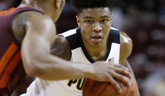 Purdue&#39;s Nojel Eastern, right, keeps his eyes on the basketball being handled by Virginia Tech&#39;s Justin Robinson during the first half of an NCAA college basketball game at the Charleston Classic in Charleston, S.C., Sunday, Nov. 18, 2018. (AP Photo/Mic Smith)