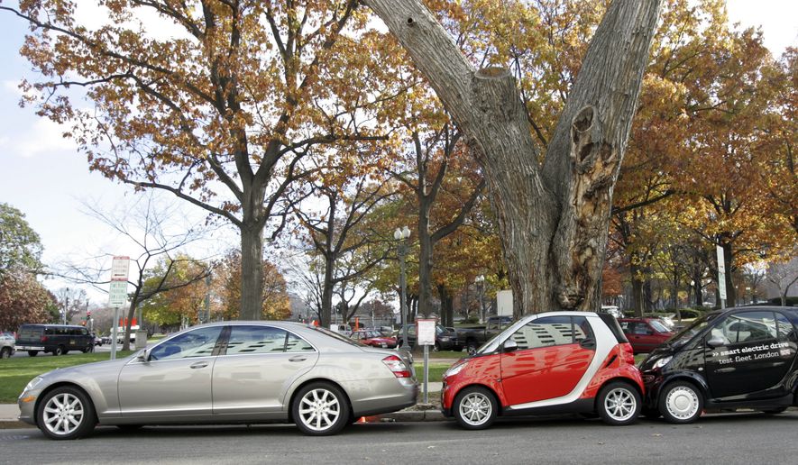 Two of Daimler AG&#39;s Fortwo new smart cars, right, are shown parked in the spaced used for a regular sized vehicle in Washington, Tuesday, Dec. 4, 2007, where the cars where unveiled to the media. Starting prices for this compact car which will go on sale sometime in the first quarter of 2008, will be $11,000. (AP Photo/Lawrence Jackson) **FILE**

