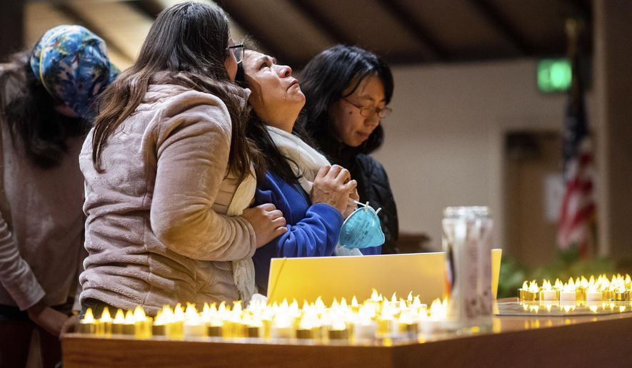 Lidia Steineman, who lost her home in the Camp Fire, prays during a vigil for fire victims on Sunday, Nov. 18, 2018, in Chico, Calif. More than 50 people gathered at the memorial for the victims. People hugged and shed tears as Pastor Jesse Kearns recited a prayer for first responders. (AP Photo/Noah Berger, Pool)