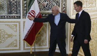 Iranian Foreign Minister Mohammad Javad Zarif, left, welcomes Britain&#39;s Foreign Secretary Jeremy Hunt for their meeting in Tehran, Iran, Monday, Nov. 19, 2018. (AP Photo/Vahid Salemi)