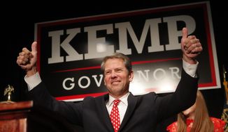FILE - In a Nov. 7, 2018 file photo, Georgia Republican gubernatorial candidate Brian Kemp gives a thumbs-up to supporters, in Athens, Ga. Georgia governor-elect Brian Kemp on Monday, Nov. 19, 2018 unveiled a transition team that includes former U.S. Health and Human Services Secretary Tom Price to begin building out his administration.(AP Photo/John Bazemore, File)
