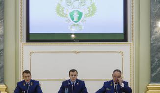 From left, an aide to the Russian Prosecutor General Mikhail Alexandrov, Russian Prosecutor General spokesman Alexander Kurennoi, and an aide to the Russian Prosecutor General Nikolai Atmoniev attend a news conference in Moscow, Russia, Monday, Nov. 19, 2018. Russian prosecutors on Monday announced new charges against Bill Browder, accusing him of forming a criminal group to embezzle funds in Russia. They also said they suspect Magnitsky&#39;s death in prison was a poisoning and said they have a &amp;quot;theory&amp;quot; Browder is behind the poisoning. (AP Photo/Pavel Golovkin)