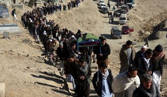 People carry the coffin of a relative who died in Thursday&#39;s suicide attack on a Shiite cultural center in Kabul, Afghanistan, Friday, Dec. 29, 2017. An Islamic State suicide bomber has struck a Shiite cultural center in Kabul, killing dozens of people and underscoring the extremist group&#39;s growing reach in Afghanistan even as its self-styled caliphate in Iraq and Syria has been dismantled. (AP Photo/Rahmat Gul)