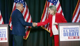 Appointed U.S. Sen. Cindy Hyde-Smith, R-Miss., and Democrat Mike Espy greet each other before their televised Mississippi U.S. Senate debate in Jackson, Miss., Tuesday, Nov. 20, 2018. (AP Photo/Rogelio V. Solis, Pool)