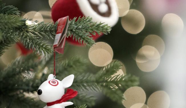 In this Friday, Nov. 16, 2018, photo, ornaments, including one with the likeness of Bullseye, the Target mascot, hang from a display at a Target store in Bridgewater, N.J. Shoppers are spending freely heading into the holidays, but heavy investments and incentives like free shipping by retailers are giving Wall Street pause. Target Inc., Kohl&#x27;s Corp., Best Buy Co. and TJX Cos. all reported strong sales at stores opened at least a year. (AP Photo/Julio Cortez)