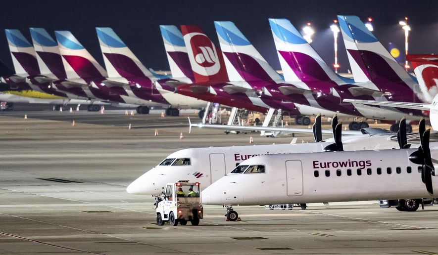 Eurowings aircraft sit on the tarmac of the airport in Duesseldorf, western Germany, Tuesday morning, Nov. 20, 2018 when the Lufthansa daughter was hit by a strike. (Marcel Kusch/dpa via AP)
