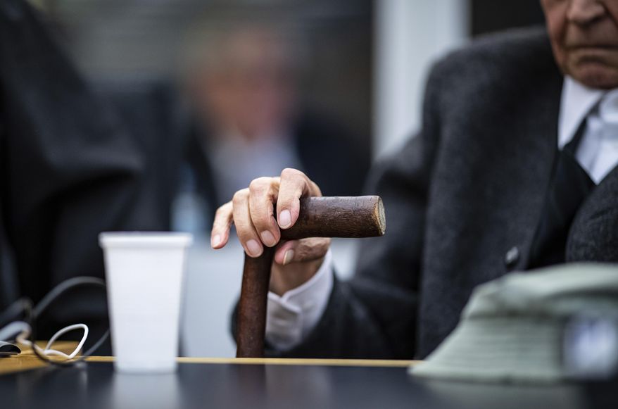 FILE - In this Nov, 6, 2018 file photo a former 94-year-old SS guard holds his walking stick at the beginning of a trial in Muenster, Germany. He is charged of accessory to murder for serving at the Nazis' Stutthof concentration camp. (Guido Kirchner/pool photo via AP, file)