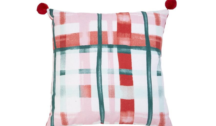 This undated photo shows a pillow available at Target. These Opalhouse toss pillows bring in some fresh, festive berry and candy hues to holiday décor. (Target via AP)