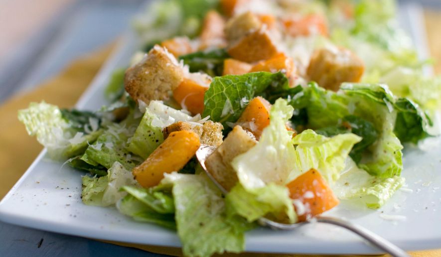 This Jan. 24, 2012, file photo shows a Caesar salad with romaine lettuce. Food regulators are urging Americans not to eat any romaine lettuce because of a new food poisoning outbreak. The FDA says it's investigating an E. coli outbreak that has sickened over two dozen people in several states. The FDA says it's working with officials in Canada, where officials are also warning against romaine lettuce. (AP Photo/Matthew Mead) **FILE**