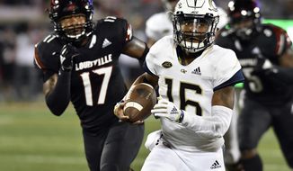 FILE - In this Friday, Oct. 5, 2018 file photo, Georgia Tech quarterback TaQuon Marshall (16) runs from the pursuit of Louisville linebacker Dorian Etheridge (17) during the first half of an NCAA college football game in Louisville, Ky. Georgia Tech have won four straight, including last week’s 30-27 overtime victory over Virginia. But the streak that is the hot topic this week is Georgia Tech’s two straight wins in Athens _ a 30-24 overtime win in 2014 and a 28-27 thriller in 2016.(AP Photo/Timothy D. Easley, File)