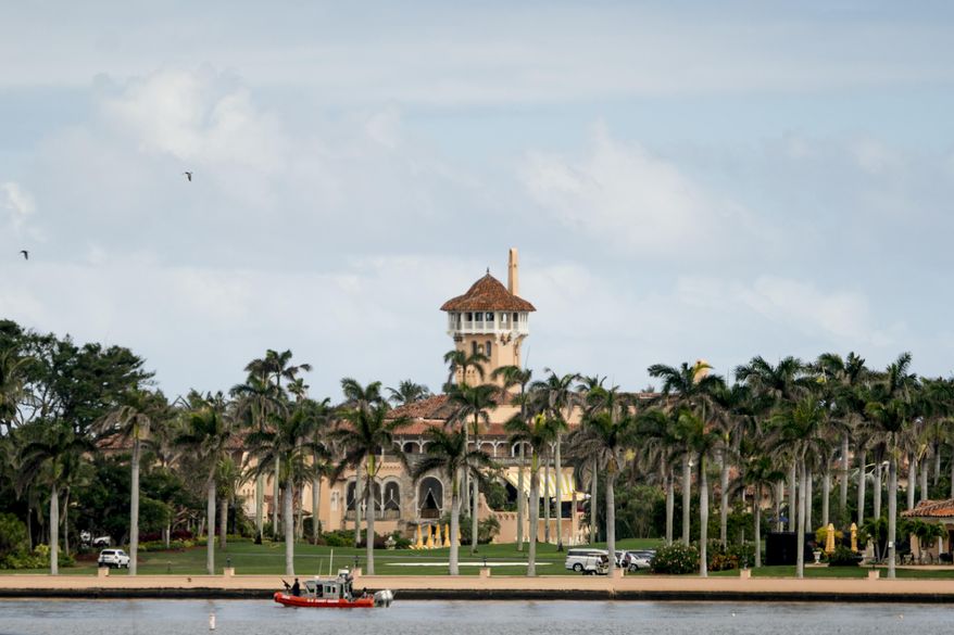 FILE - In this Feb. 19, 2018, file photo, Mar-a-Lago is visible from a motorcade carrying President Donald Trump, in Palm Beach, Fla. Trump is making his return to Florida, kicking off the Palm Beach social season at his “winter White House.” All presidents have had their favorite refuges from Washington. But none has drawn the fascination or raised the ethical issues of Mar-a-Lago, where Trump spends his days mixing work, business and play in the company of dues-paying members and staff are on high alert for those seeking influence.(AP Photo/Andrew Harnik, File)