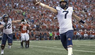 FILE - In this Nov. 3, 2018, file photo, West Virginia quarterback Will Grier (7) scores the game-winning two-point conversion during an NCAA college football game against Texas, in Austin, Texas.  Grier, a senior, will play in his final home game Friday night, Nov. 23, when No. 12 West Virginia hosts No. 6 Oklahoma. (Nick Wagner/Austin American-Statesman via AP, File)
