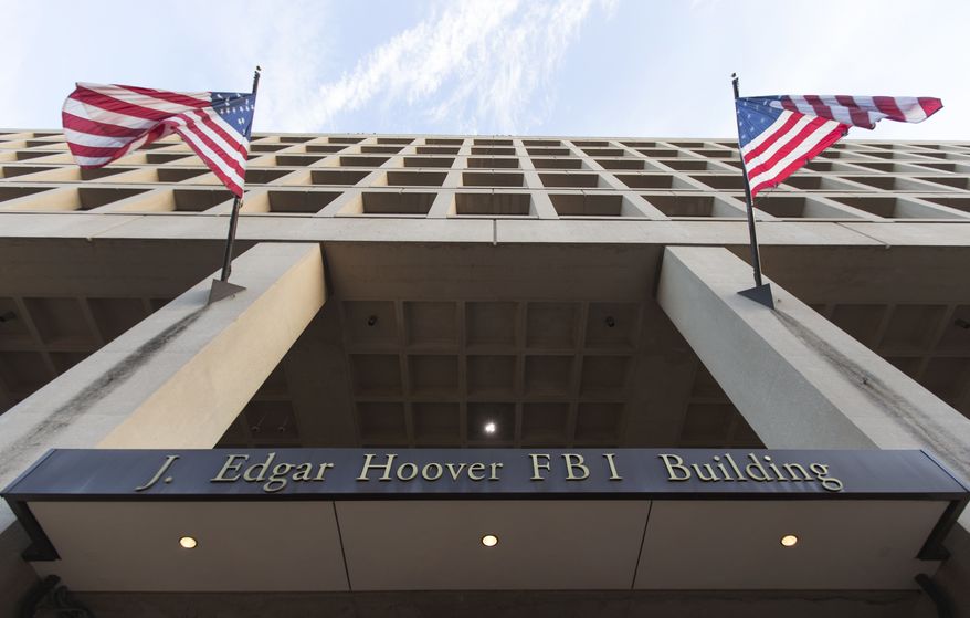 The Pennsylvania Avenue entrance of the J. Edgar Hoover Federal Bureau of Investigations (FBI) Building is seen in Washington, Thursday, Nov. 30, 2017. (AP Photo/Carolyn Kaster/File)
