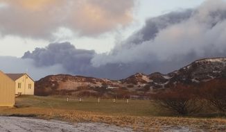 A black ash cloud from Alaska&#x27;s Mount Veniaminof passes the community of Perryville, Alaska, on Wednesday, Nov. 21, 2018. Alaska Volcano Observatory scientists said the overnight ash emissions from Mount Veniaminof generated an ash plume that drifted more than 150 miles (241 kilometers) to the southeast. (Victoria Tague via AP)