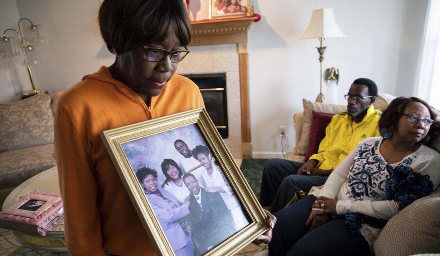 Glenda O&#39;Neal, mother of of Dr. Tamara O&#39;Neal, shows a photo of her family at their home in LaPorte, Ind., Tuesday, Nov. 20, 2018. Dr. Tamara was one of the three people fatally shot Monday at Mercy Hospital, a Chicago hospital. (Zbigniew Bzdak/Chicago Tribune via AP)