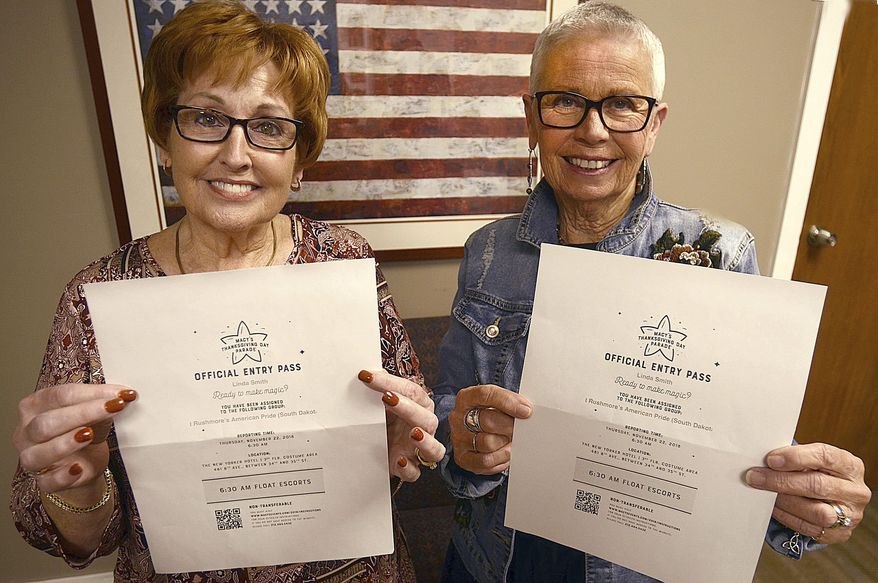 Linda Smith and Linda Dodson hold official entry passes to the Macy's Thanksgiving Day Parade as float escorts for the Mount Rushmore's American Pride float during an interview in Hickory, N.C. on Nov. 16, 2018. (Robert C. Reed/The Daily Record via AP)