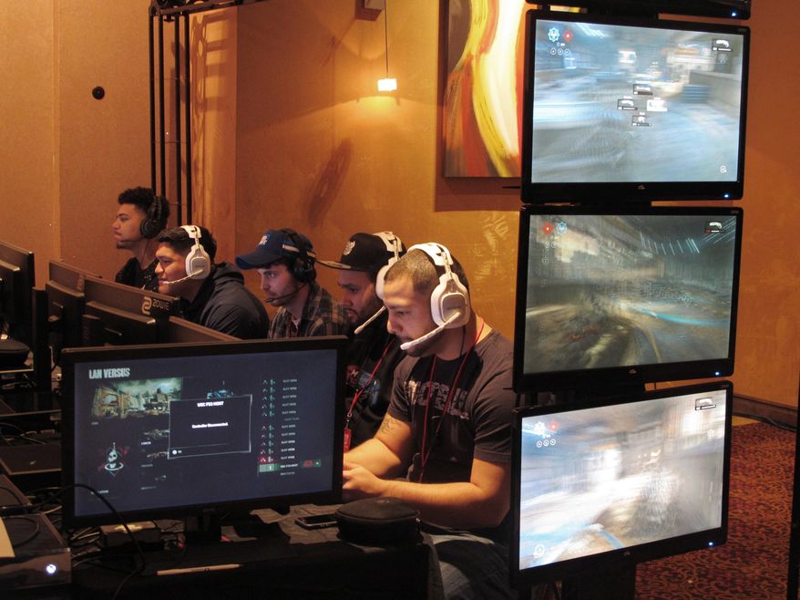In this March 31, 2017, file photo, video game players compete against one another in an esports tournament at Caesars casino in Atlantic City, N.J. (AP Photo/Wayne Parry, File) **FILE**