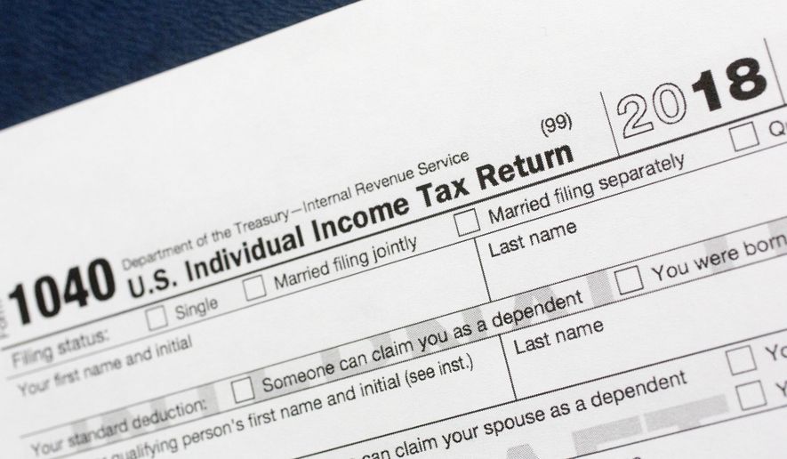 FILE- This July 24, 2018, file photo shows a portion of the 1040 U.S. Individual Income Tax Return form for 2018 in New York. The $1.5-trillion tax overhaul includes the end of a 75-year-old deduction on alimony payments. It may seem too early to start thinking about your tax return, but procrastination could cost you thousands of dollars. (AP Photo/Mark Lennihan, File)
