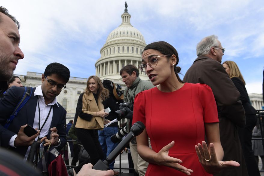 In this Nov. 14, 2018, file photo, Rep.-elect Alexandria Ocasio-Cortez, D-N.Y., talks with reporters following a photo opportunity on Capitol Hill in Washington, with the freshman class. (AP Photo/Susan Walsh, File)