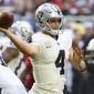 Oakland Raiders quarterback Derek Carr (4) throws against the Arizona Cardinals during the first half of an NFL football game, Sunday, Nov. 18, 2018, in Glendale, Ariz. (AP Photo/Ross D. Franklin)