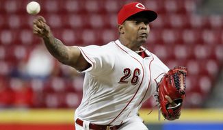 FILE - In this Sept. 10, 2018 file photo Cincinnati Reds relief pitcher Raisel Iglesias throws in the ninth inning of a baseball game against the Los Angeles Dodgers in Cincinnati. Iglesias agreed to a three-year contract guaranteeing $24,125,000, a deal that avoided arbitration. Iglesias reached a $27 million, seven-year agreement in 2014 that allowed him to void the remainder of the deal once he was eligible for salary arbitration. (AP Photo/John Minchillo, file)