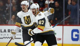 Vegas Golden Knights left wing Max Pacioretty (67) celebrates his goal against the Arizona Coyotes with Shea Theodore, left, during overtime of an NHL hockey game Wednesday, Nov. 21, 2018, in Glendale, Ariz. The Golden Knights won 3-2. (AP Photo/Ross D. Franklin)