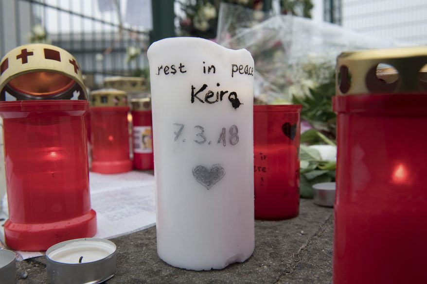 In this Monday, March 12, 2018 photo candles are laid down at the entrance of a sports hall in Berlin, Germany to honor the 14 years old Berlin student Keira who was killed on March 7, 2018. A Berlin court has sentenced a German teenager for killing the 14-year-old girl to nine years in prison in a case that was politically exploited by far-right groups who falsely claimed that the perpetrator was a migrant. (Paul Zinken/dpa via AP)